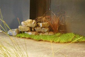 Rocks (poly carved) with real turf and grass. Dressing the set for Dancing Llunasa with Lynn Blake. Set designed by Cordelia Ashwell