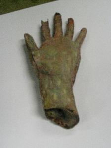 Hand: Cast in latex from a plaster mould and painted into to look decayed